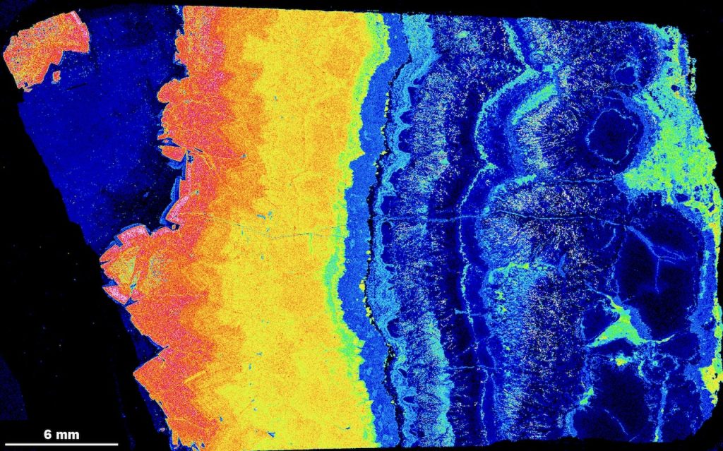 Relative intensity map of iron content in minerals, represented by a colour gradient from blue (low) to pink (high).