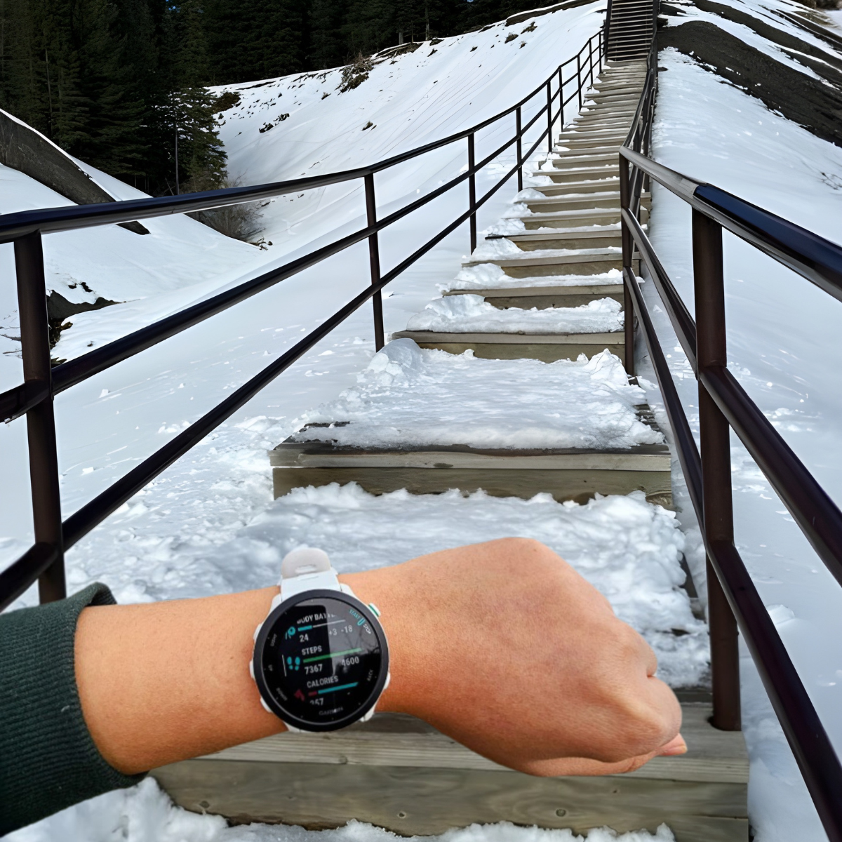 Garmin watch on wrist recording health data facing a snow-covered bridge symbolizing the uncertain journey of chronic illness.