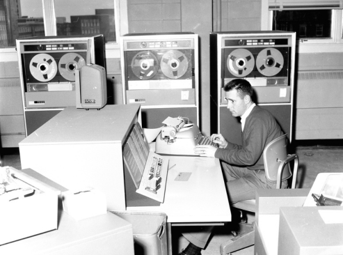 A man operating an IBM 1620 Computer